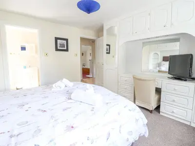 a bedroom with a bed and a desk and a tv at 1 The Beeches in Llangollen