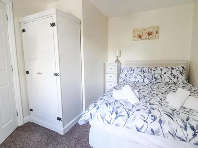 a bedroom with a bed and a closet at 1 The Beeches in Llangollen