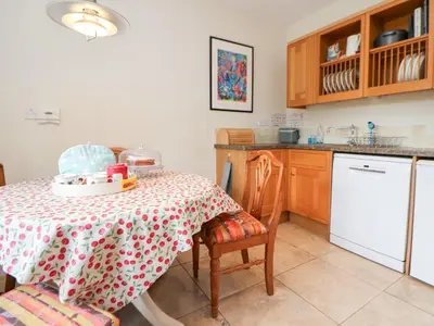 a kitchen with a table with a table cloth on it at Bryn Howell Stables in Trevor
