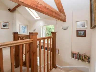 a staircase in a home with a skylight at Bryn Howell Stables in Trevor