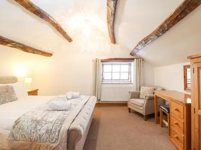 a bedroom with a bed and a desk at Isallt in Llanbedr