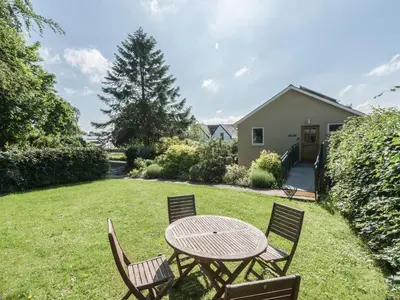 a table and chairs in the yard of a house at The Schoolhouse Brewhouse in Bishops Castle