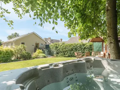 a bath tub in a yard with a tree at The Schoolhouse Brewhouse in Bishops Castle
