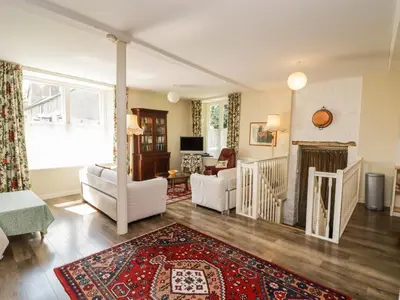 a living room with a couch and a fireplace at The School Room in Kington