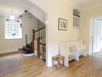 a living room with stairs and a stair case at Bryn Cemlyn in Llanfachreth