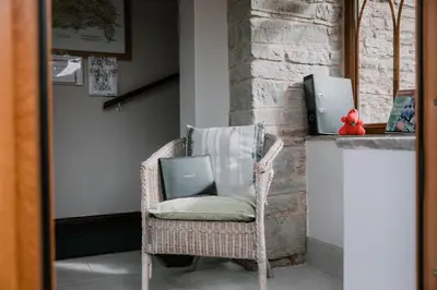 a wicker chair with a laptop on a counter at Stargazer's Loft in Clifford
