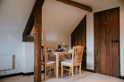 a dining room with a wooden table and chairs at Stargazer's Loft in Clifford