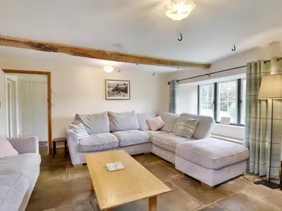 a living room with two couches and a table at The Birches in Craswall