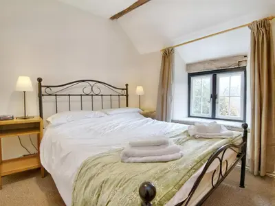 a bedroom with a bed with two towels on it at The Birches in Craswall