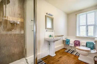 a bathroom with a sink toilet and a shower at 2 Siluria Cottage in New Radnor