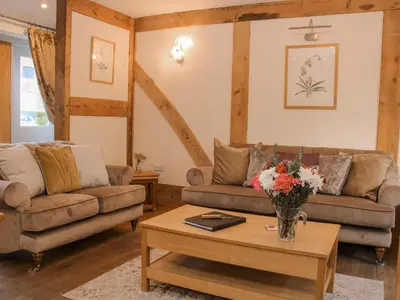 a living room with two couches and a coffee table at The Turnip House in Acton Scott