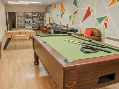 a room with a pool table with cuesticks on it at The Turnip House in Acton Scott