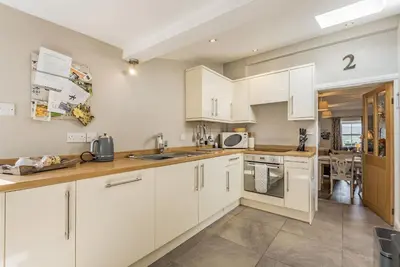 a kitchen with white cabinets and a counter top at 2 Bryn Tirion in Tanygrisiau