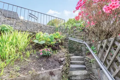 a set of stairs with flowers and plants at 2 Bryn Tirion in Tanygrisiau