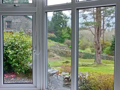 a window with a view of a garden seen through it at Llechwedd in Dolgellau