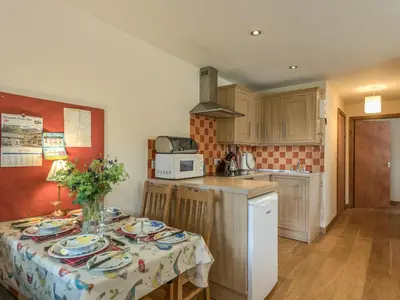 a kitchen with a table with plates on it at The Schoolhouse Bakehouse in Bishops Castle