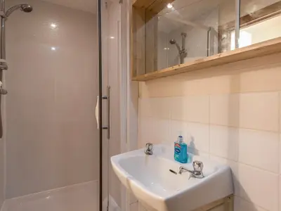a bathroom with a sink and a shower at The Schoolhouse Bakehouse in Bishops Castle