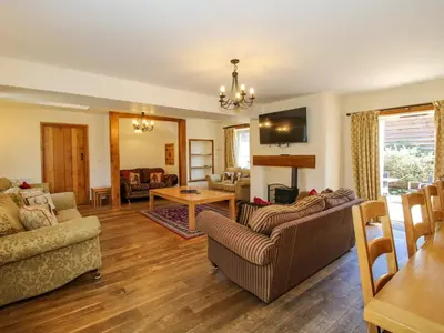a living room with two couches and a table at Trooper's Barn in Acton Scott