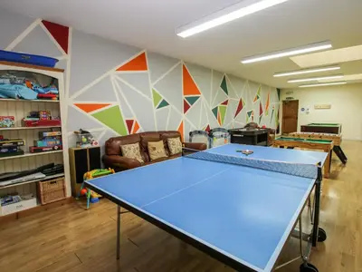 a ping pong table in a room with a ping pong ball at Trooper's Barn in Acton Scott