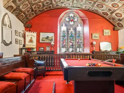 a room with a pool table in a church at St Mary's in Tal-y-llyn