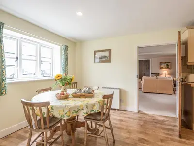 a kitchen and dining room with a table and chairs at Hope Hall Barn in Bromlow