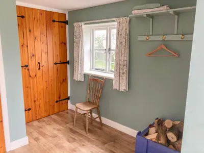 a room with a chair and a window at Hope Hall Barn in Bromlow