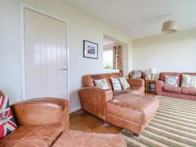 a living room with leather chairs and a couch at The Villa in Harlech