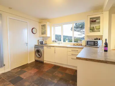 a kitchen with a sink and a dishwasher at The Villa in Harlech