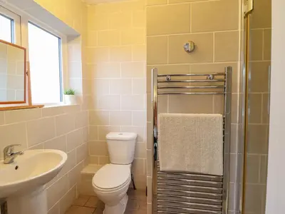a bathroom with a toilet and a sink at The Villa in Harlech