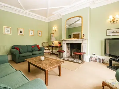 a living room with a couch and a fireplace at Wheelbarrow Castle in Stoke Prior