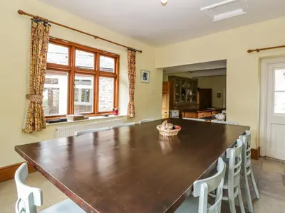 a large dining room with a wooden table and chairs at Wheelbarrow Castle in Stoke Prior
