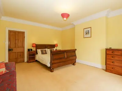 a bedroom with a bed and a dresser at Wheelbarrow Castle in Stoke Prior