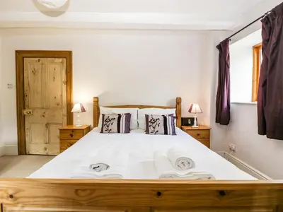 a bedroom with a large white bed with two pillows at Wheelbarrow Castle in Stoke Prior