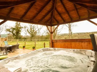 a hot tub in a gazebo with at Cwmcelyn in Nantmel