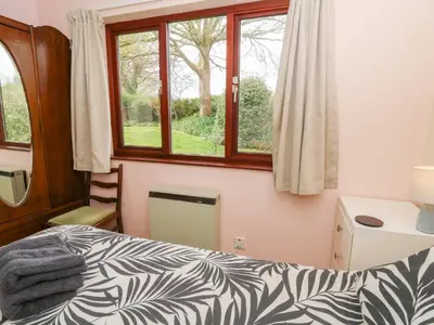 a bedroom with a bed and a window at Bryn yr Haf in Llanfair Clydogau