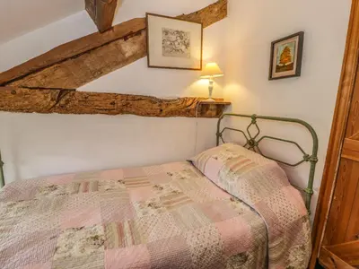 a bedroom with a bed in a room at Beudy Dolpebyll in Llangadfan