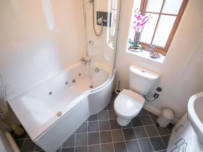 a bathroom with a tub and a toilet and a sink at The Wilderness in Bromlow