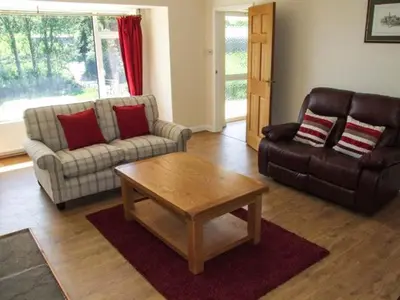 a living room with a couch and a coffee table at Cwmgilla Farm in Knighton
