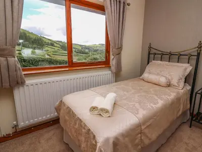 a bedroom with a bed and a window with a view at Drainbyrion Farm House in Van