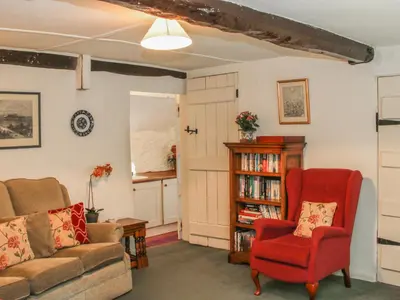 a living room with a couch and a chair at Penymaes in Chirk