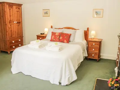 a bedroom with a bed with towels on it at Penymaes in Chirk