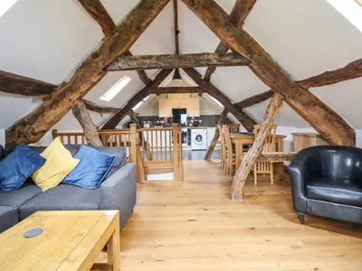 a living room with a couch and a table at Ysgubor Las in Dolgellau