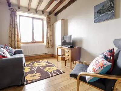 a living room with a couch and a tv at Groes Lwyd in Gwyddelwern