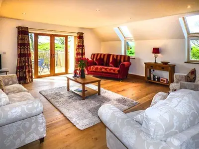 a living room with white furniture and a red couch at Brynhir Farm in Llandrindod Wells