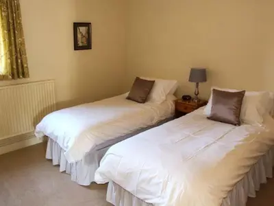 two beds sitting next to each other in a room at Harris House in Ludlow