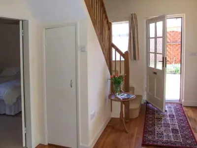 a room with a stairway with a door and a table at Harris House in Ludlow