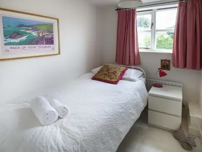 a bedroom with a white bed with towels on it at Gatehouse in Painscastle