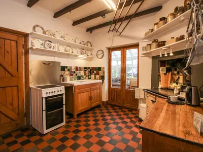 a kitchen with a checkered floor at Hill Brow in Acton Scott