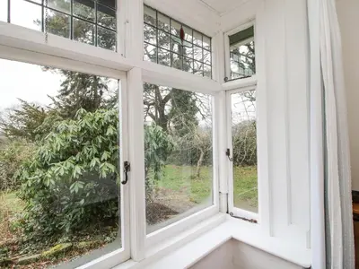 an open window with a view of a garden at Hill Brow in Acton Scott