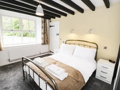 a bedroom with a large white bed with white pillows at Hen Gelligemlyn - The Annexe in Llanfachreth